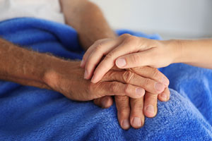 a patient's hands being held