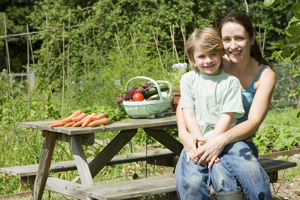 mother and son with vegetables on picnic table