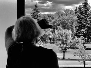 photo of a woman looking out a window