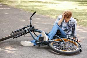 boy who has fallen off a bicycle